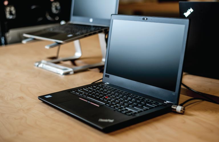 IBM ThinkPad laptop on table in retail display area of Hi-Tech office