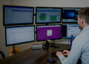 A highly productive staff member uses 6 monitors to display data from cloud applications